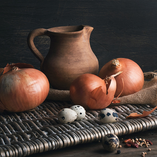 Still life with onions, quail eggs and clay jug
