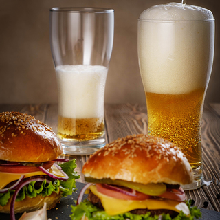 Hamburger and beer in a glass.