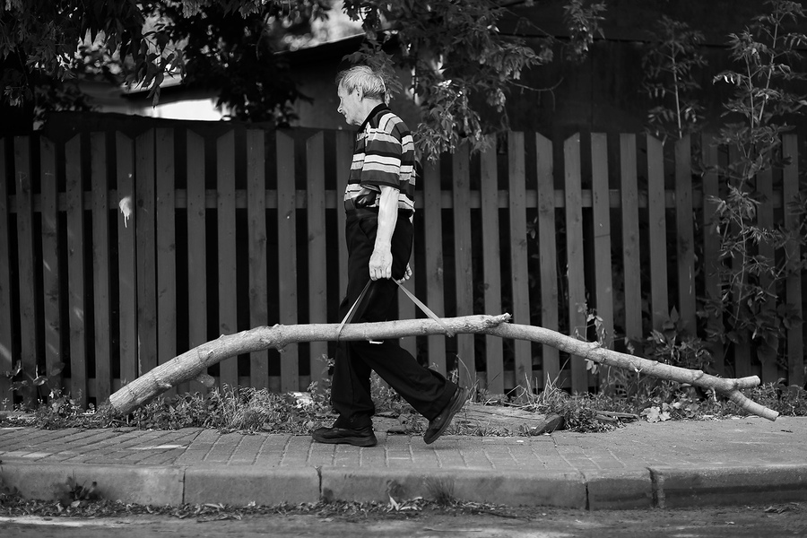 Мужчина необычным способом переносит бревно в центре г.Могилева,Беларусь