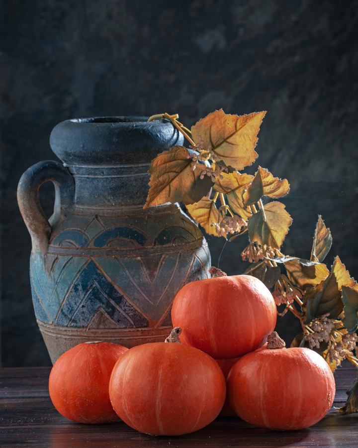 Still life with pumpkins and  jug.
Toned.Colors of autumn.