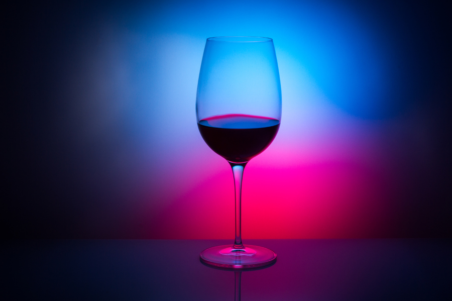 wine glass, empty, sloping, with cracks, transparent, gradient background red and blue