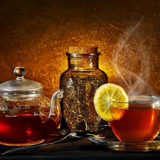 glass teapot and cup on golden background