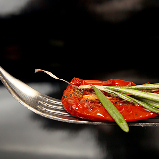 Slice of dried tomato on fork