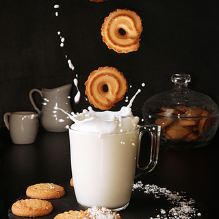 Falling cookies to glass of milk