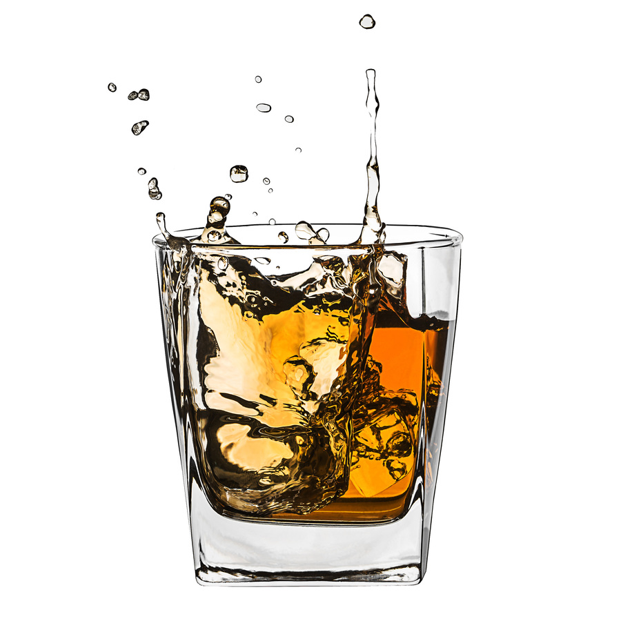 Glass of splashing whiskey isolated on white
