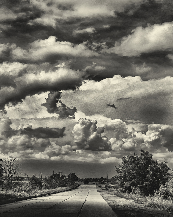 Travel to Ukraine road in an industrial area with gorgeous clouds.