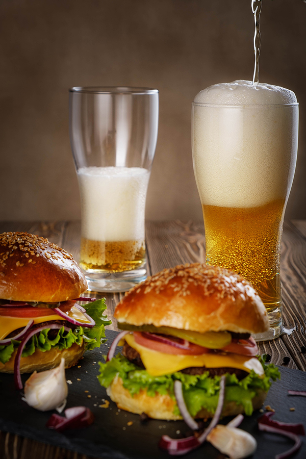 Hamburger and beer in a glass.