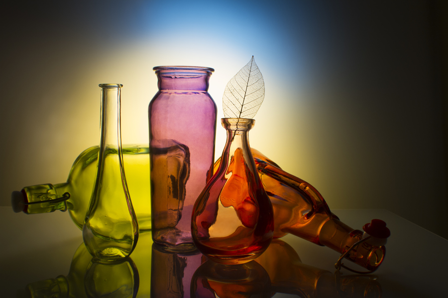 glass, empty colored botels, gradient background