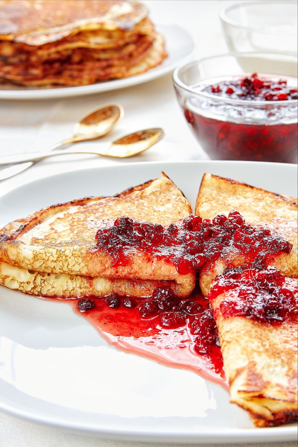 Healthy breakfast with fresh hot pancakes with berry jam