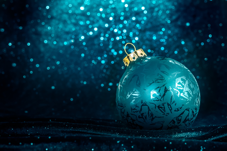 Decorative Christmas tree ball in front of sparkling background